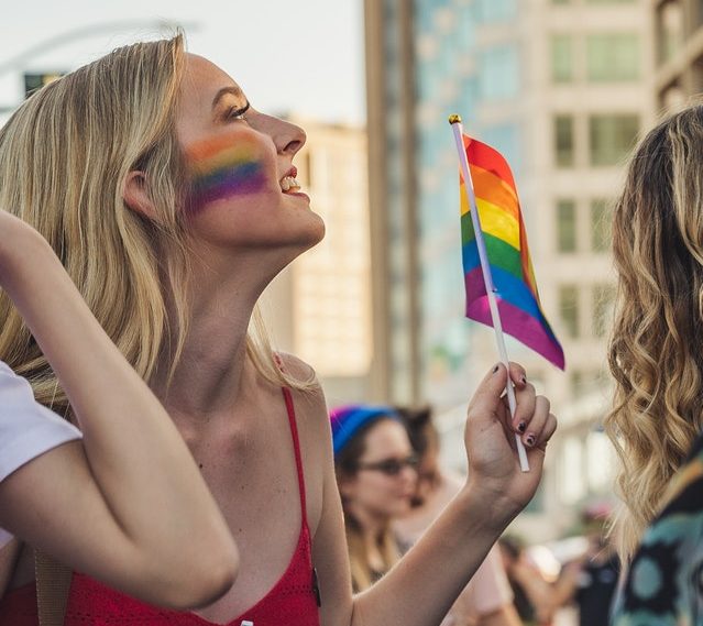 Woman holding Pride rainbow flag
